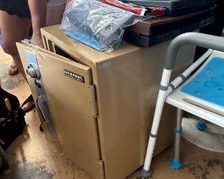 Safe, code and paperwork on top in blue folder