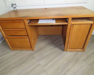 Honey oak desk with drawers and storage.