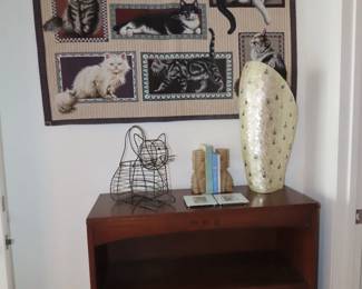 Bookcase, cat tapestry.
