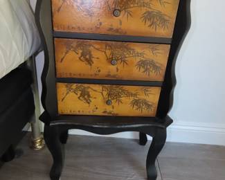 Three drawer chest with Asian accents.