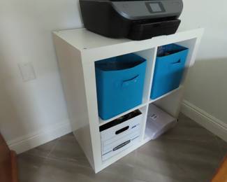 Cubbie storage with baskets and printer.