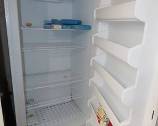 Large upright Frigidaire freezer.