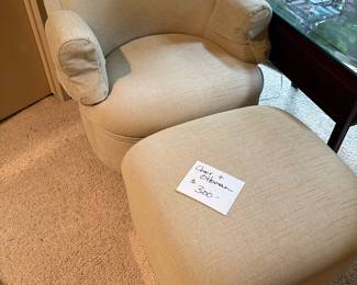 Upholstered chair and ottoman, chair is on a gold plinth type thing