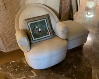 Chair and ottoman on a bit of a pedestal plinth, also casters