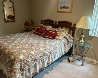 Queen-size bed with headboard and two glass-top nightstands