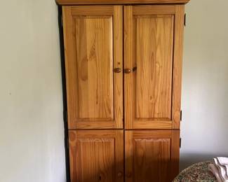 Oak armoire with upper and lower cabinet storage
