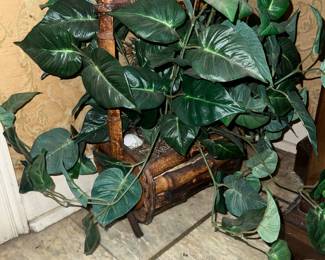 Fake plant in wood basket