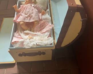 Trunk open w doll and wardrobe inside 