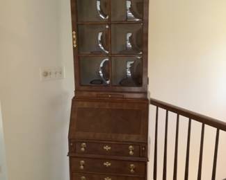 Antique secretary with bubble glass in the cabinet door.  Opens to a writing space and cubby holes for letters and stationary, pens etc.  in excellent condition.