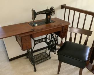 Antique Singer sewing machine in singer cabinet model 15 and  chair