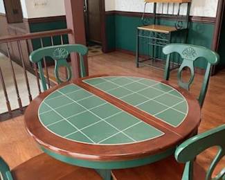 Country 42” round table with green tile top.  4 Chairs have same paint color.  One 15” leaf. Presale $275