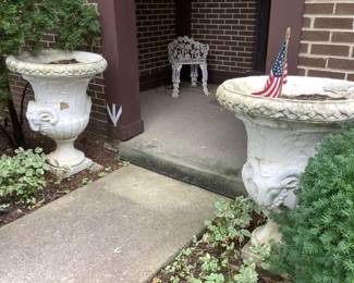 Two large cement urns with a ram design.  Pair is $400 and available presale