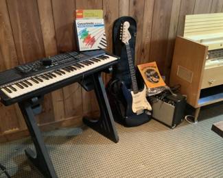 Keyboard and Fender guitar with amplifier/speaker