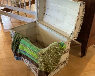 Old curved top trunk, quilts