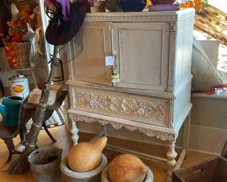 White vintage hutch, concrete planter, antique school desk