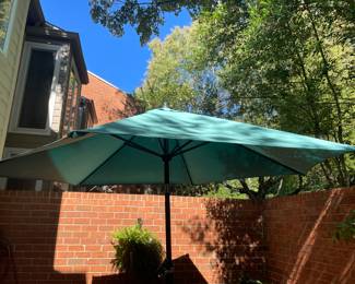 A1002. Large offset Outdoor umbrella, teal fabric, adjustable tilt and rotation with crank handle $25