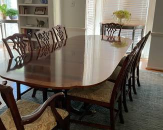 A99 Baker double pedestal, banded inlay dining table with two 16” leaves; pristine condition. 70” x 46”. Can extend to 102” Also comes with heat resistant pads. Table $1800 Hickory Chippendale-style dining chairs; 8 total; 6 side chairs and 2 armed chairs, newly recovered with classic tapestry fabric $125 each Or save with complete set $2800