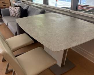 BoConcept expandable stone dining table and leather chairs