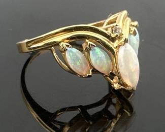 Opal and diamond cluster design set in 14kt. Split shank holds 5 marquise cut opals. Ring size 7