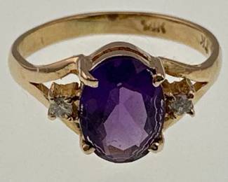 Size 5 ring has center oval cut amethyst (6mm long) with two small diamonds and is set in 14kt gold