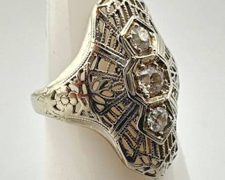 Size 4 Art Deco filigree diamond and platinum elongated dinner ring has slight dome shape. It is set with three diamonds