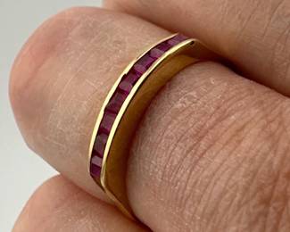 Size 6.5 square cut rubies in channel set marked 750 (18kt gold)