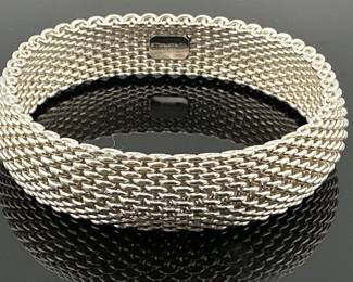 Tiffany Somerset mesh sterling silver bracelet; approx. 2.5”diam x 0.75”W. It weighs 60.77g. Comes with branded Tiffany pouch