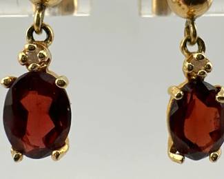 Oval garnet and diamond 14kt gold dangle earrings; 1.63g. One back is marked 14kt and other marked 10kt