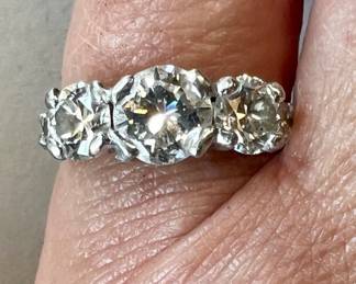 Appraised for $6,000.00 this 2 carat platinum diamond ring, center diamond approximate 1.01 carats, side diamonds 1/2 carat each, and outside melee diamonds approximately 1/8 carat each. Center diamond: SI-1 clarity, F color. Side diamonds are both VS-2 clarity, F color. Melee diamonds are VS-1 to VS-2 clarity, F-G color. Satin platinum contains 10% Iridium. Weighs: 4.12g. Appraisal included dated 9/25/25 for FMV. Ring size approx. 5.5-6.