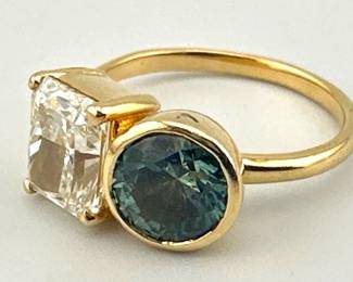 Stunning size 4.5 ring has radiant cut diamond (1.71 carats, VS-1 clarity, J color) and bezel set round Montana sapphire (1.70 carats, type II clarity, medium to medium-dark grayish green-blue color); 3.70g. February 2025 appraisal report included. RESERVE ITEM