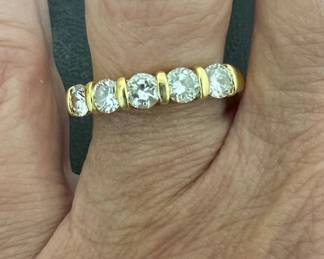 18kt five diamond anniversary band in yellow gold setting, size 9; 1ctw, H/VS2. It weighs 4.39g. Comes with Schwarzschild purchase certificate from 1997.