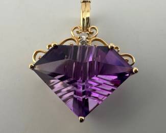 Unusual custom cut triangular shaped amethyst (approx. 22mm wide) is set in 14kt gold with two diamonds set on top. Pendant/enhancer clasp has hinged opening