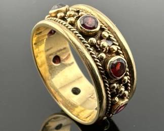 Size 9 Etruscan style cigar band ring has eight garnet stones set in marked 14kt gold