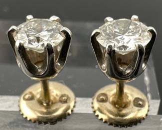 Round cut diamond stud earrings have 14kt gold backs. Diamonds are approx. 4mm, H color with estimated 0.90 carats; one stone is SI clarity, other is SI-I clarity