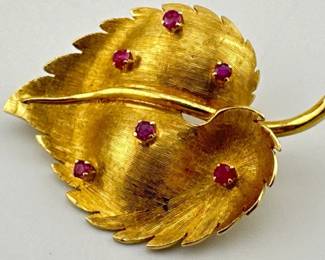 Vintage Italian 18kt gold leaf pin with brushed surface and scattered rubies is signed KG. Kurt Gutman (1891-1968) was a premier jewelry designer known for his Art Deco pieces. His jewelry was worn by royalty and celebrities and is quite sought after today.
