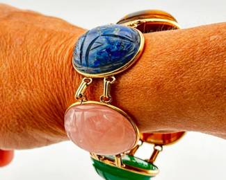Beautiful 14kt oversized scarab bracelet with tiger eye, lapis, rose quartz, green chalcedony and red agate. Each scarab stone is 1.25"L. Replacement safety chain is marked gold filled. Bracelet measures 7"L