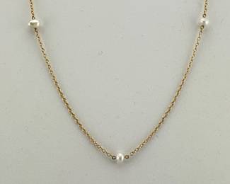 Elsa Peretti 18kt gold necklace has five Baroque pearls and is marked Tiffany and Co. and signed Peretti who designed the Pearls by the Yard necklace; 14.5"L, 2.87g. Includes Tiffany suede pouch