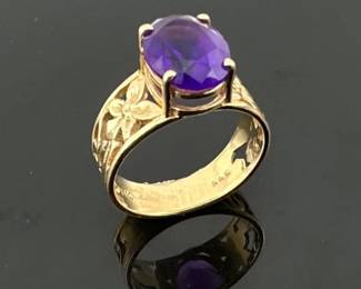 Size 5.5 oval amethyst (approx. 6mm x 7mm) ring set in 14kt wide floral cut out band