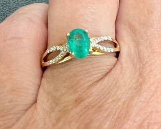 14kt natural emerald and diamond ring (1 ctw.). Oval natural emerald has two open bands of diamonds on shoulders. Ring size 8.5