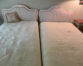 Pair of twin French provincial beds with upholstered headboards