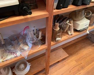 Entire lower shelf is a Cuisinart food processor with many attachments