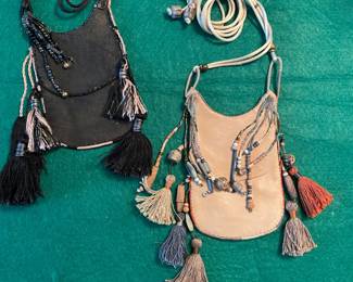 Calf leather cross body pouches with beads and tassels 
