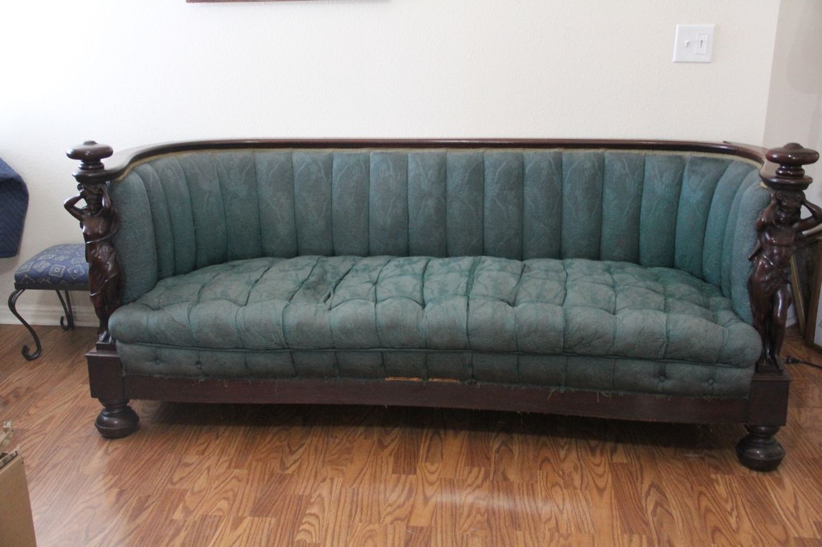 Magnificent American Empire period barrel back sofa featuring exceptional carved male and female caryatid figures supporting each arm.  Mid-19th century