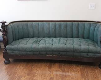 Magnificent American Empire period barrel back sofa featuring exceptional carved male and female caryatid figures supporting each arm. Mid-19th century