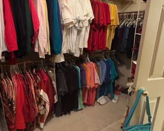 Large walk in closet with a lot of clothes 