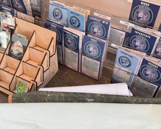This lot features a collection of displays for maps & stickers, retail signage, maps, and more.