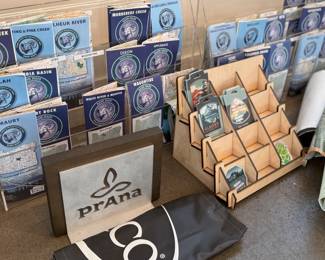 This lot features a collection of displays for maps & stickers, retail signage, maps, and more.