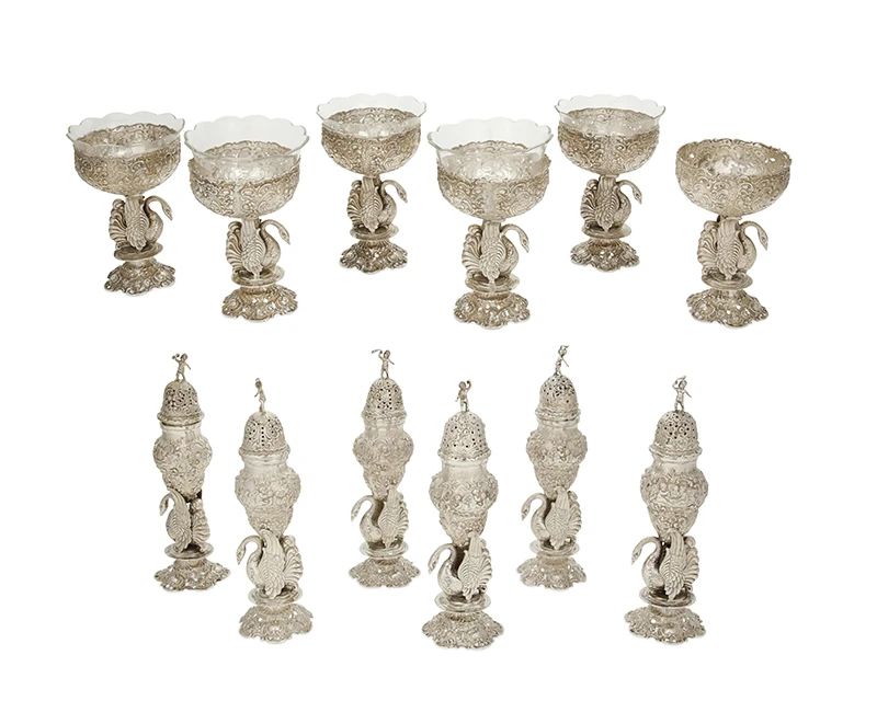 1
A group of J. D. Schleissner & Söhne salt cellars and pepper casters
Late 19th/early 20th century; Germany
Most marked .800 and with maker's mark of J. D. Schleissner Söhne, Hanau
The salts with pierced bowls and scalloped etched glass inserts, each piece with swan-form stems and repoussé detailing
12 pieces
Each pepper: 8.5" H x 2.375" Dia.; Each salt with glass: 6" H x 3.875" Dia.
Total weight: 87.9 oz. troy approximately
Estimate: $1,000 - $1,500