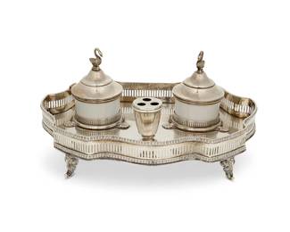 5
An Italian .800 silver inkstand
Mid/late 20th century
Stand with Italian marks for .800 and Milan; each well marked in green: Limoges / France
The two porcelain wells with silver hinged lid and swan-form finial, set in a stand with pierced gallery and raised on scrolled feet
Overall: 4.25" H x 9.75" W x 7.125" D
26.9 gross oz. troy approximately
Estimate: $500 - $700