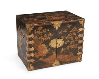 245
A Japanese gilt and lacquered wood chest
19th century
The chest with brass hardware, opposed handles, and lock plate, and interior drawer pulls, the exterior decorated in gilt with rural village scenes in low relief, featuring cabinet doors revealing five interior drawers, each front conformingly decorated
21.5" H x 27" W x 18" D
Estimate: $600 - $800